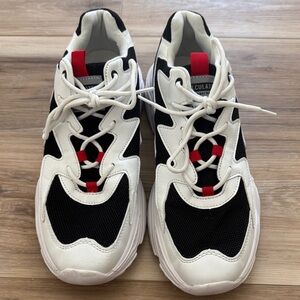 Trendy Black and White Sneakers with Red Details